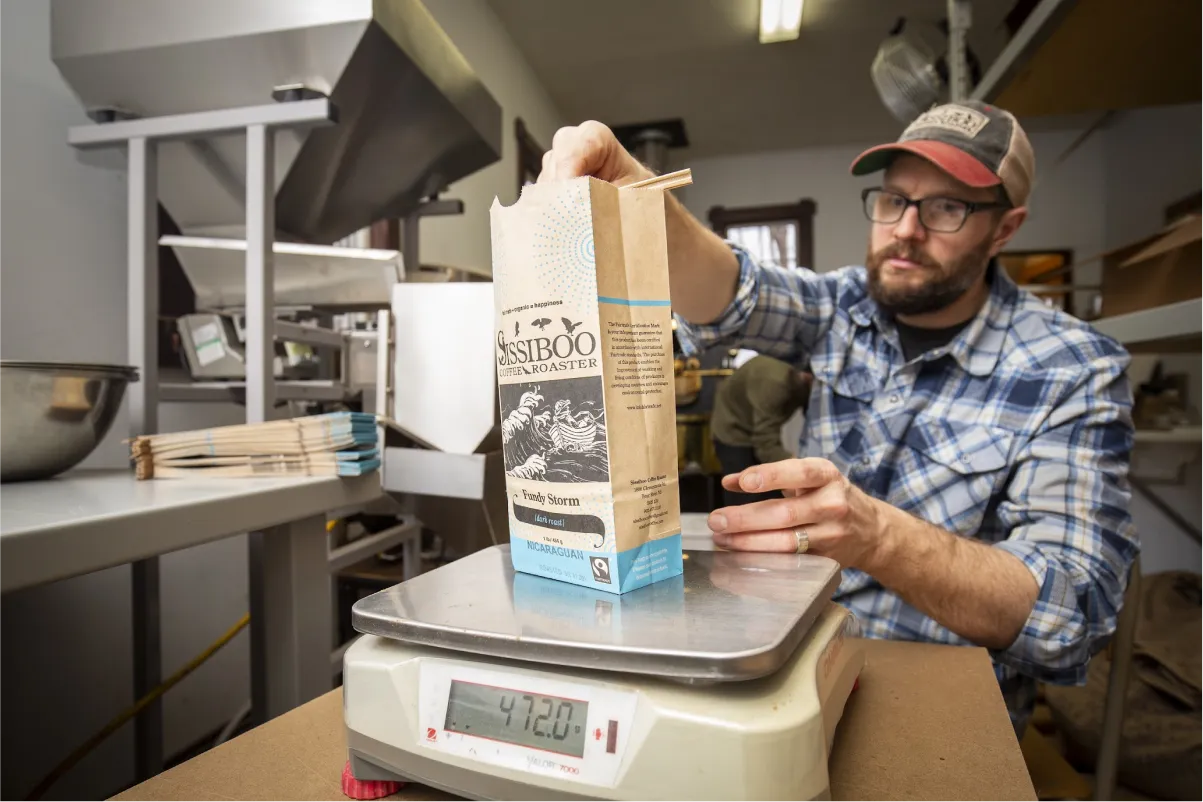 man-weighing-coffee-beans-on-a-scale